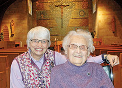 Benedictine Sister Eugenia Reibel, right, will turn 100 on May 24. Here, she shares a smile with Benedictine Sister Mary Luke Jones inside the chapel of the St. Paul Hermitage in Beech Grove. (Photo by John Shaughnessy)