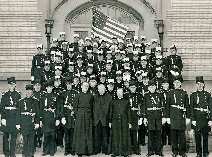 In this photo, a group of the Knights of St. John stand on the steps of St. Mary Church in Richmond, now part of St. Elizabeth Ann Seton Parish. Though the year of this photo is unknown, the American flag shown has only 48 stars, indicating that this picture was likely taken before the addition of Alaska and Hawaii as the final two states in 1959.