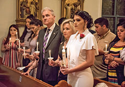 Cassandra Guerra, far right in the front pew, listens intently during the Easter Vigil Mass on April 20 at St. Thomas the Apostle Church in Fortville. During the Mass, she was baptized, confirmed and received her First Communion. (Submitted photo by Gary Potts)