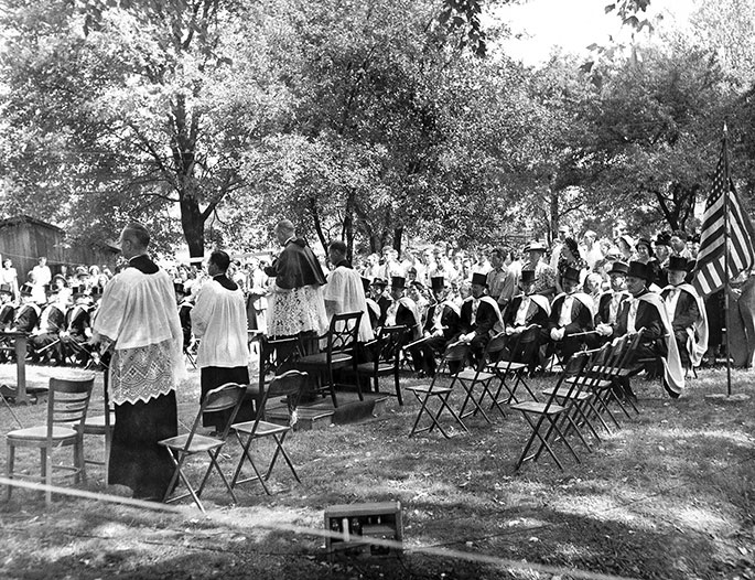 In this photo, an outdoor Mass takes place as part of “Rural Life Day” at St. Michael Parish in Bradford in July 1949. Archbishop Paul C. Schulte is seen from behind. This event in the New Albany Deanery faith community included a field Mass, talks by clergy and laity on the needs of rural Catholics, a picnic, games and folk dances, and solemn benediction of the Blessed Sacrament. The National Catholic Rural Life Conference was founded on Nov. 11, 1923, to serve the needs of Catholic farmers in America. Local “Rural Life Days” are among the events sponsored by the conference, which still occur today in some areas of the country.