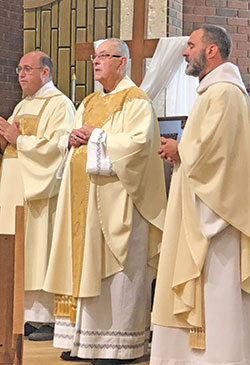Father John Fink, middle, celebrates a Mass on May 26 at St. Michael Church in Bradford to mark the 50th anniversary of his priestly ordination. Deacon John Jacobi, left, assists at the Mass. Father Aaron Pfaff, pastor of St. Michael Parish, was a concelebrant. (Submitted photo)