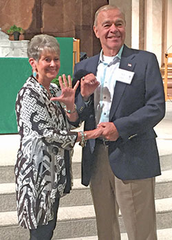 After the annual archdiocesan Golden Wedding Anniversary Mass at SS. Peter and Paul Cathedral in Indianapolis on Aug. 25, Jan and Charles Lauck of St. Barnabas Parish in Indianapolis make a “50” with their hands to indicate the number of years they’ve been married. (Photo by Natalie Hoefer)