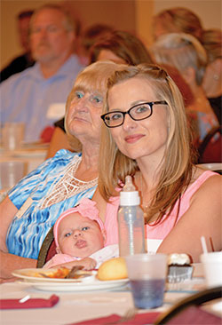 Briana Pennington holds her daughter during a banquet on Sept. 12 celebrating the 30th anniversary of the Pregnancy Care Center of Southeast Indiana, located in Lawrenceburg. (Photo by Natalie Hoefer)