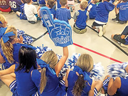 A cheerleader at Immaculate Heart of Mary School in Indianapolis holds up an oversized foam hand declaring “We’re #1” during a school pep rally on Sept. 26 to celebrate the school’s national recognition as a Blue Ribbon School of Excellence by the U.S. Department of Education. (Submitted photo)