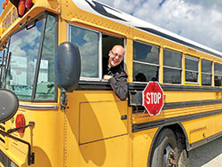 Father Michael Keucher, archdiocesan vocations director, says earning a license to drive a school bus has helped him lead the Catholics he serves as pastor of St. Joseph Parish in Shelbyville and as sacramental minister of St. Vincent de Paul Parish in Shelby County to grow closer to Christ by taking them on pilgrimages and service trips. “Maybe it’s just a matter of getting people on the bus,” says Father Keucher. “Get on the bus. And God has allowed me to be behind the wheel.” Read his story on page 2B. (Submitted photo)