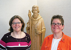 Part of triplets with their brother Eric, Benedictine sisters Susan, left, and Jill Reuber have often shared the same path in life, but their roads to their vocations took different turns. (Photo by John Shaughnessy)