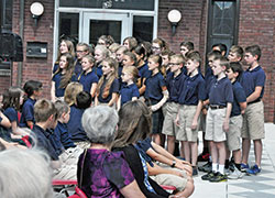 Students of Lumen Christi Catholic School in Indianapolis sing a patriotic song during a Sept. 23 ceremony to dedicate and bless a plaque to honor four students of the former Latin School of Indianapolis who died while serving in the U.S. military. (Photos by Sean Gallagher)