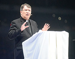 Archbishop Christophe Pierre, apostolic nuncio to the United States, speaks on Nov. 22 in Lucas Oil Stadium in Indianapolis to the 20,000 people attending the National Catholic Youth Conference. (Photo by Sean Gallagher)