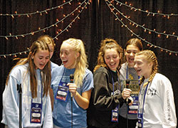 Youths from the Diocese of Des Moines, Iowa, have a good time together performing karaoke in the thematic village in the Indiana Convention Center at the National Catholic Youth Conference in Indianapolis on Nov. 21. (Photo by John Shaughnessy)