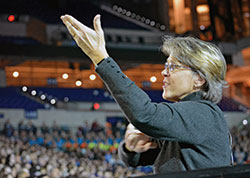 Joyce Ellinger uses American Sign Language to interpret for the hearing impaired during the National Catholic Youth Conference closing Mass at Lucas Oil Stadium in Indianapolis on Nov. 23. (Photo by Natalie Hoefer)