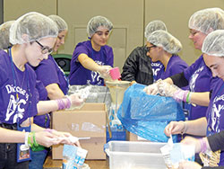 Teenagers from the Diocese of Springfield, Mass., put together meals on Nov. 23 during the National Catholic Youth Conference in Indianapolis for Pack Away Hunger, an Indianapolis-based organization that provides nutritious dehydrated meals to local food pantries throughout Indiana. They also work with international populations. (Photo by Mike Krokos)