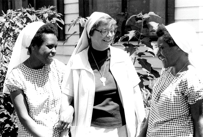 The Sisters of St. Francis in Oldenburg had a long-standing mission in Papua New Guinea, from 1960-2011. They initially taught in grade schools but when the country was declared independent in 1975, local teachers took over the grade school teaching roles, and the Franciscan sisters began teaching in high schools and colleges. In this 1984 photo, Oldenburg Franciscan Sister Brendan Boyle, center, speaks with Franciscan Sisters of Mercy in Papua New Guinea.