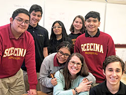 Amy Fix, this year’s recipient of the archdiocese’s highest honor for an educator, gets a hug from Ani Ximeyo Coyotl. The teacher at Father Thomas Scecina Memorial High School in Indianapolis is also surrounded by other smiling Scecina students: Sammy Villanueva Pupo, left, Angel Anaya, Stephanie Meza, Katherine Guerra-Cordova, Edson Cuellar Mora and Thiago Rodrigues. (Submitted photo by Beth Murphy)
