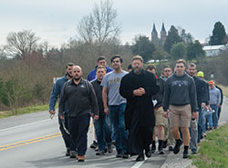 Led by Benedictine Father Christian Raab, seminarians in formation for the priesthood at Saint Meinrad Seminary and School of Theology in St. Meinrad walk on March 13 along State Road 62 outside of the southern Indiana town while on a pilgrimage to the Shrine of Our Lady Monte Cassino. They sought Mary’s intercession in response to the growing outbreak in the U.S. of the coronavirus. (Submitted photo by Corey Bruns)