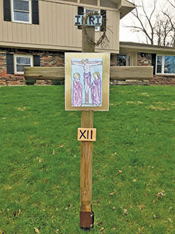 The 12th station, Jesus Dies on the Cross, is displayed in the yard of a Hill Valley neighborhood home in Indianapolis. Catholic families in the neighborhood joined to create a 2.5-mile homemade Stations of the Cross. (Submitted photo by Rachel Miller)
