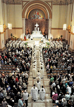 Archbishop Charles C. Thompson and some 140 priests serving in central and southern Indiana process on April 16, 2019, into SS. Peter and Paul Cathedral in Indianapolis at the start of the annual archdiocesan chrism Mass. This year’s chrism Mass was postponed due to the coronavirus pandemic. (File photo by Sean Gallagher)