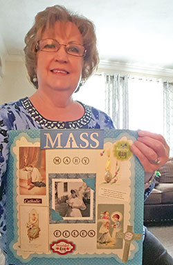 Mary Ellen Cestaro, a member of Holy Family Parish in New Albany, holds up her first Communion banner. (Submitted photo)