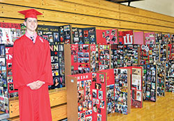 Michael Mark, a graduating senior of Cardinal Ritter Jr./Sr. High School in Indianapolis, poses on May 27 with his classmates, figuratively speaking, in the form of story boards each senior’s family made for their graduation ceremony. (Photo by Natalie Hoefer)