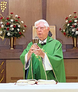 Father John Geis celebrates Mass on July 5 at St. Maurice Church in Napoleon. The 84-year-old retired priest has been a sacramental minister at the Batesville Deanery faith community since 2011. He is the only archdiocesan priest thus far to have tested positive for the coronavirus. He was diagnosed with it in April, but was able to return to Napoleon to celebrate Mass on June 7. (Submitted photo)