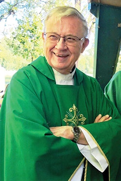 Father James Bonke shares a smile after Christ the King Parish’s Mass at Broad Ripple Park, both in Indianapolis, in September 2019. (Submitted photo)