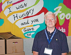 John Ryan takes a break from helping people in need at the client-choice food pantry of the Indianapolis council of the Society of St. Vincent de Paul, a food pantry that serves about 3,000 people a week, making it one of the largest in the country. (Photo by John Shaughnessy)