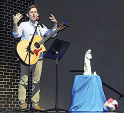 Matt Faley, then-director of Young Adult and College Campus Ministry for the archdiocese, leads those attending the archdiocesan Gathering of Disciples in song on Sept. 8, 2018. (File photo by Mike Krokos)