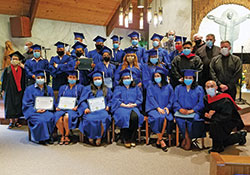 Graduates of the Archdiocese Hispanic Pastoral Leadership Institute pictured with various priests after a graduation ceremony at St. Andrew the Apostle Church in Indianapolis on July 3. In all, 22 individuals received diplomas as part of the Archdiocese's eighth class of pastoral leadership graduates. (Photo sent)