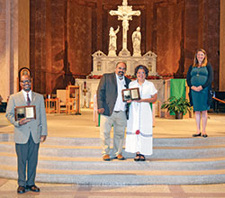 Brie Anne Varick, director of the archdiocesan Office of Human Life and Dignity, right, poses with this year’s winners of the office’s Archbishop Edward T. O’Meara Respect Life Award—Eric Slaughter, left, and Maria Guadalupe (“Lupita”) Aguayo and her husband Mario Soberanos Armenta, center—at SS. Peter and Paul Cathedral in Indianapolis after the annual Respect Life Mass on Oct. 4. (Photo by Natalie Hoefer)