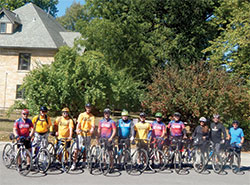 A group of cyclists taking part in the annual “Biking for Babies” poses on Sept. 19 in the parking lot of Our Lady of Lourdes Parish in Indianapolis. (Photo by Mike Krokos)