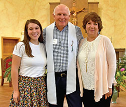 Gene Gadient, center, smiles with his daughter Katie, left, and his wife Lisa after being welcomed into the full communion of the Church during a special Mass at St. Roch Church in Indianapolis on July 12. (Submitted photo)