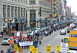 During the third annual Indiana March for Life on Jan. 22 in Indianapolis, a mass of about 1,100 pro-life advocates march up Meridian Street toward Monument Circle, far outnumbering a small group of protesters on the monument steps. (Criterion file photo by Natalie Hoefer)