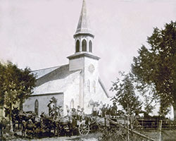 Parishioners pose in their horse-drawn wagons in front of St. Mary Church in Navilleton in this photo from 1900, nine years after the structure was built. The church looks much the same today. (Submitted photo)