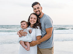 Sean and Paige Hussey pose for a photo with their daughter Emma during a vacation to Santa Rosa Beach, Fla., in July of 2020. (Submitted photo)