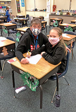 As she works with her students, Sandi Kirchner of St. Mary School in North Vernon encourages them to follow her lead in “trying to be the best person I can be every day.” Here, she helps one of her students, Kennedei Roll. (Submitted photo)
