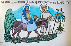 A painting of St. Joseph, the Blessed Virgin Mary and the Christ Child adorns a wall outside the crypt chapel of the Archabbey Church of Our Lady of Einsiedeln at Saint Meinrad Archabbey in St. Meinrad. The painting was created in the late 1990s by the late Benedictine Father Donald Walpole. (Photo courtesy of Saint Meinrad Archabbey)
