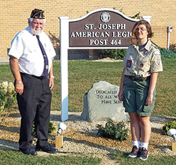 Renee Bauer earned the distinction of Eagle Scout by creating a tribute to military veterans at the St. Leon American Legion Post 464. A junior at Oldenburg Academy of the Immaculate Conception in Oldenburg, Renee poses for a photo by the tribute with Jerry Maune, commander of the St. Leon American Legion Post. (Submitted photo)