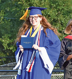 A member of the Class of 2020 at Bishop Chatard High School in Indiana—and its valedictorian that year—Margaret Corns shows off her diploma during the school’s commencement ceremony on July 23, 2020. (Submitted photo)