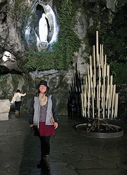 Helen Stephon of St. Barnabas Parish in Indianapolis poses in front of the shrine in Lourdes, France, in 2017. (Submitted photo)
