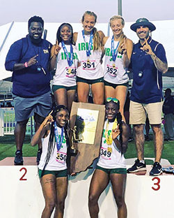 The runners and coaches of the girls’ track team of Cathedral High School in Indianapolis are all smiles as they celebrate their 2021 Indiana High School Athletic Association Track and Field State Championship victory on June 5 in Indianapolis. Kaylah Pitts, left, and Alexis Parchman are in the bottom row while Coach Josiah Daniels, left, Milani Kimble, Reese Sanders, Sidney Sanders and Coach John O’Hara form the top row. (Submitted photo)