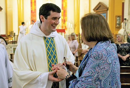 Dominican Father James Pierce Cavanaugh greets his mother, Marianne Cavanaugh on May 22 in St. Pius V Church in St. Louis after a Mass in which he was ordained a priest for the Chicago-based Dominican Province of St. Albert the Great. Father James Pierce grew up as a member of St. Pius X Parish in Indianapolis, where his mother is still a member. (Submitted photo)