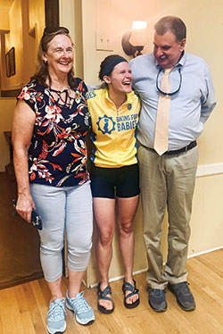 Emily Mastronicola shares a moment of joy with her parents, Deb and Norm Mastronicola, during a stop in Indianapolis on July 13 amid the national ride of Biking for Babies. (Submitted photo)