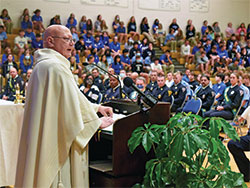 Father John McCaslin, pastor of St. Monica Parish in Indianapolis and a chaplain for the Indianapolis Fire Department, preaches a homily during a Sept. 10 Mass at Bishop Chatard High School in Indianapolis. (Photo by Sean Gallagher)