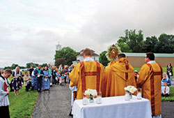 Father Jerry Byrd, second from right, leads Benediction during a eucharistic procession on June 3 at St. Joseph Parish in Jennings County, which he serves as pastor. Assisting him are Father Jeffrey Dufresne, left, and Father James Brockmeier. (Submitted photo)