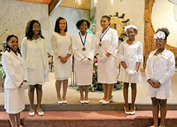Members of Junior Daughters Court #97 pose at St. Andrew the Apostle Church in Indianapolis after the St. Peter Claver Feast Day Mass on Sept. 12. They are, from left, Gabrielle Guynn, Precious Olarewaju, Aniya Gibson, Gianna Peerman, Marissa Bardo, Preston Williams and Nydia Collins. (Photo by Natalie Hoefer)
