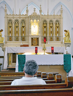 A woman prays before the Blessed Sacrament in St. Bridget of Ireland Church in Liberty on Sept. 10 during a 31-day adoration campaign held by St. Bridget Parish and St. Gabriel Parish in Connersville. (Photo by Natalie Hoefer)