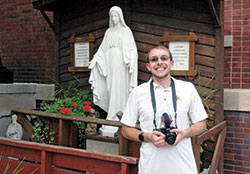 After a night of capturing tragedies across central Indiana as a news photographer for an Indianapolis television station, Max Schroeder often comes to the Blessed Mother shrine in front of Our Lady of the Most Holy Rosary Church in Indianapolis to pray for the people who have died and their family and friends. (Photo by John Shaughnessy)
