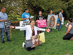 A group of Hispanic members of Our Lady of Grace Parish in Noblesville, Ind., in the Lafayette Diocese take part on Oct. 9 in the 40 Days for Life prayer campaign outside a Planned Parenthood abortion facility in Indianapolis. (Photo by Sean Gallagher)