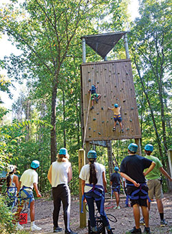 Teens take on a rock wall challenge during Hispanic Family Camp at Catholic Youth Organization Camp Rancho Framasa in Nashville on Sept. 18. (Photo by Natalie Hoefer)