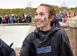 Lily Cridge’s joy has no limits as the junior from Bishop Chatard High School in Indianapolis celebrates winning the girls’ state championship cross country race of the Indiana High School Athletic Association on Oct. 30. (Submitted photo)