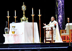 Voluntas Dei Father Leo Patalinghug speaks during adoration on the second night of the National Catholic Youth Conference in Lucas Oil Stadium in Indianapolis on Nov. 19. (Photos by Natalie Hoefer)